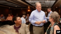 FILE - Democratic Senate nominee Doug Jones, center, talks to supporters, Jennifer L. Greer, right, and Janet Crosby, left, as he campaigns at Niki's West restaurant, Wednesday, Sept. 27, 2017, in Birmingham, Alabama.