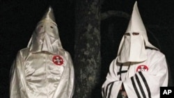 FILE - Two Ku Klux Klansmen take part in an interview near Pelham, North Carolina, Dec. 2, 2016. Glendon Crawford, sentenced to 30 years in prison, Dec. 19, 2016, for trying to build a bomb, was described as a self-professed member. 