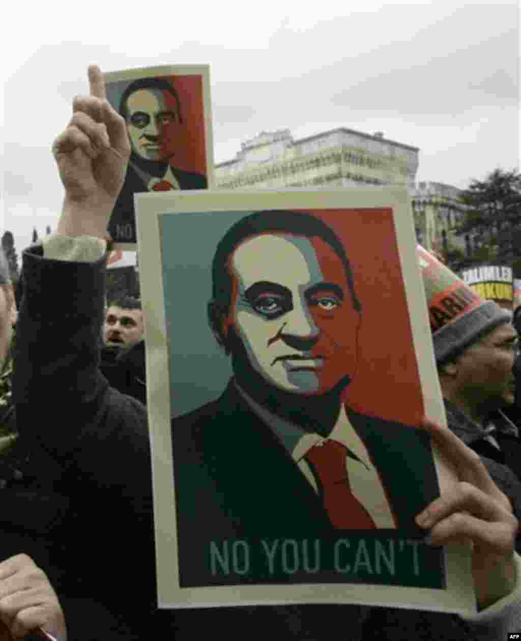 A man shout slogans while showing a poster of Egyptian President Hosni Mubarak in an imitation of the Obama election campaign slogan Yes we Can, as several hundreds of pro-Islamic demonstrators hold a protest in show of solidarity with protestors in Egypt