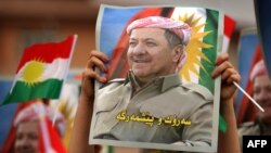 Iraqi Kurdish students of the Salahaddin University hold posters of Iraqi Kurdish leader Masoud Barzani during a rally in his support in Irbil, the capital of autonomous Iraqi Kurdistan, Oct. 30, 2017.