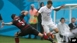 Germany's Mats Hummels, left, and United States' Fabian Johnson challenge for the ball during the group G World Cup soccer match between the USA and Germany at the Arena Pernambuco in Recife, Brazil, June 26, 2014. 