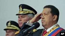 Venezuela's President Hugo Chavez salutes during a ceremony celebrating his nation's 200th anniversary of independence, at Miraflores Palace in Caracas, July 5, 2011