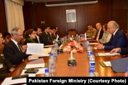 U.S. special representative for Afghan reconciliation, Zalmay Khalilzad, right, and Pakistani Foreign Secretary Tehmina Janjua, second left, lead their respective delegations in talks in Islamabad, Pakistan, Jan. 17, 2019.
