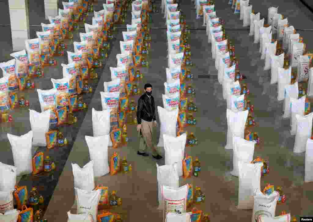 An Afghan man checks bags of free food donated for people in need, during the coronavirus disease (COVID-19) outbreak in Kabul, Afghanistan.
