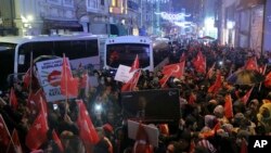 Supporters of Turkey's President Recep Tayyip Erdogan wave flags outside the Dutch consulate to protest, in Istanbul, March 12, 2017. 