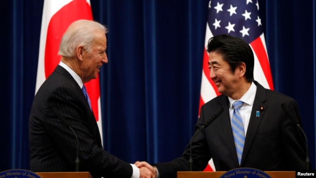 U.S. Vice President Joe Biden (L) shakes hands with Japan's Prime Minister Shinzo Abe at the end of their joint news conference following their meeting at the prime minister's official residence in Tokyo, Dec. 3, 2013. Biden urged Japan and China to lower