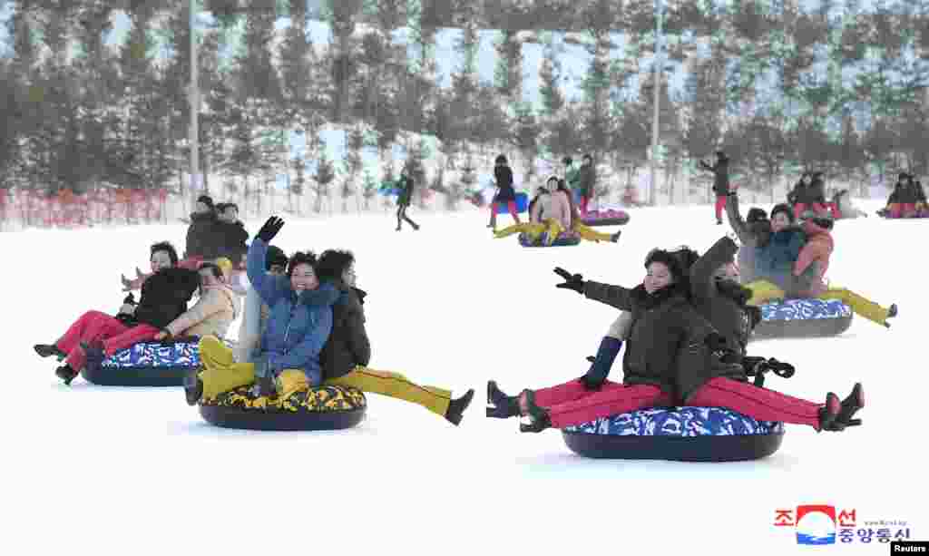 People play in the snow at the Yangdok Hot Spring Resort, North Korea, in this undated photo released by North Korea&#39;s Korean Central News Agency (KCNA).