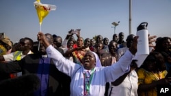A nun in the crowd shouts that the country needs peace as Pope Francis prepares to leave in his vehicle from the airport in Juba, South Sudan Friday, Feb. 3, 2023.