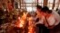 Local residents light candles during a ceremony to celebrate Pchum Ben, or Ancestors' Day at Krang Thnung Buddhist pagoda on the outskirts of Phnom Penh, Cambodia, Monday, Sept. 28, 2015. The traditional 15-day festival, which commemorates the spirits of the dead, began on Monday. (AP Photo/Heng Sinith)