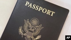 This May 25, 2021 photo shows a U.S. Passport cover in Washington. The Biden administration says American citizens holding recently expired U.S. passports will be allowed to return home from abroad on that document until the end of year. (AP Photo…