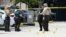 Law enforcement officials work the scene of a shooting outside a banquet hall near Hialeah, Fla., May 30, 2021. 