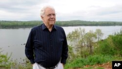 FILE - Jimmy Johnson outside his Tennessee River home in Sheffield, Ala., April 14, 2015. Johnson, a founder of the Muscle Shoals Sound Studios and a guitarist with the famed studio musicians nicknamed "The Swampers" has died. He was 76.