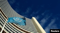 FILE - The flag of the International Atomic Energy Agency (IAEA) flies in front of its headquarters in Vienna, Austria.