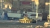 An image grab taken from a video uploaded on YouTube on August 22, 2012 allegedly shows a Syrian army tank deploying the the Nahr Aishe neighborhood of Damascus, August 22, 2012. 