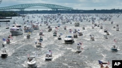 Hundreds of boats idle through downtown on the St. Johns River during a rally, June 14, 2020, in Jacksonville, Fla., celebrating President Donald Trump's birthday.
