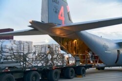 FILE - Airmen from the 146th Airlift Wing of the California Air National Guard deliver 200 ventilators to the New York Air National Guard's 105th Airlift wing at Stewart Air National Guard Base, adjacent to Newburgh, N.Y., April 7, 2020.