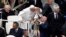Pope Francis kisses a child at the end of a mass in Saint Peter's Square at the Vatican, May 19, 2013. 