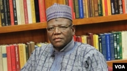 Jigawa State Governor Sule Lamido (R) waits on set for interview to begin.