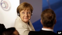 German Chancellor Angela Merkel listens to the opening address during an EU summit meeting at the Orazi and Curiazi Hall in the Palazzo dei Conservatori in Rome, March 25, 2017.