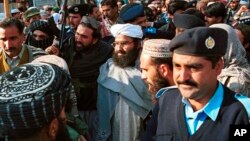 FILE - Masood Azhar, center, leader of Jaish-e-Mohammad arrives in Islamabad, Pakistan, Jan. 27, 2000. Pakistan’s Foreign Ministry said, May 1, 2019, that Azhar has been added to a United Nations sanctions blacklist by the Security Council.