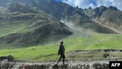 FILE - An Indian army soldier stands guard at Zoji La pass in Kargil, connecting Srinagar and the federal territory of Ladakh bordering China, Aug. 29, 2023.