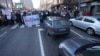 People stop traffic and stand in silence in front of the state-run TV headquarters in Belgrade, Serbia, on Dec. 27, 2024. They are part of ongoing protests that erupted after a concrete canopy fell last month and killed 15 people.