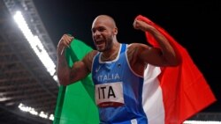 Lamont Jacobs of Italy celebrates after taking the gold medal in the final of the men's 4 x 100-meter relay at the 2020 Summer Olympics, Friday, Aug. 6, 2021, in Tokyo, Japan. (AP Photo/Charlie Riedel)