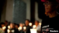 FILE - Activists and supporters of the Right2Know Campaign hold a night vigil outside the Constitutional Court in Johannesburg, Sept. 19, 2011.