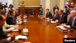 Egypt's interim Foreign Minister Nabil Fahmy (3rd L) speaks as German Foreign Minister Guido Westerwelle (2nd R) looks on during their meeting in Cairo, August 1, 2013. 