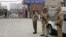 Indian police officers stand outside the district court where five men accused in a gang rape were brought to appear in New Delhi, January 7, 2013. 