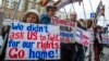 FILE - Protesters holding anti-American signs are seen gathered in front of the U.S. Embassy at a rally against what they see as American mingling in Russia's internal affairs, in Moscow, Russia, March 7, 2015.