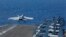 In this May 3, 2019, photo released by the U.S. Navy, An F/A-18E Super Hornet from VFA 25 launches from the flight deck of the Nimitz-class aircraft carrier USS Abraham Lincoln.