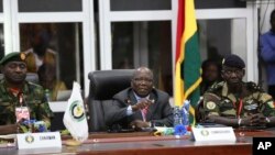 ECOWAS commissioner Abdel-Fatau Musah, centre, speaks during a press briefing following the Extraordinary Meeting of the ECOWAS Committee of Chiefs of the Defence Staff, in Accra, Ghana, Friday, Aug. 18, 2023. 