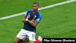 FILE - France's Kylian Mbappe celebrates after scoring a goal during the World Cup game against Argentina in Kazan, Russia, June 30, 2018.