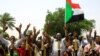 FILE - Sudanese people celebrate the signing of a constitutional declaration between the deputy head of the Sudanese Transitional Military Council, Mohamed Hamdan Dagalo, and Sudan's opposition alliance leader Ahmad al-Rabiah, in Khartoum, Aug. 4, 2019.
