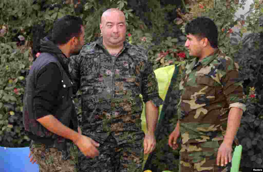 Brian Wilson, center, who said he is a U.S. citizen and a former soldier from Ohio, has joined the Kurdish People's Protection Units (YPG). Qamishli, Syria, Oct. 6, 2014.