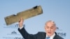 Israeli Prime Minister Benjamin Netanyahu holds up a remnant of what he said was a piece of Iranian drone which was shot down in Israeli airspace during his speech at the Munich Security Conference, Germany, Feb. 18, 2018. 