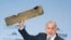 Israeli Prime Minister Benjamin Netanyahu holds up a remnant of what he said was a piece of Iranian drone which was shot down in Israeli airspace during his speech at the Munich Security Conference, Germany, Feb. 18, 2018. 