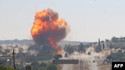 A fireball bursts from an explosion reportedly targeting a joint Turkish-Russian patrol on the M4 highway, near the Syrian town of Ariha in the rebel-held Idlib province.
