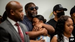 Family members of Rayshard Brooks attend a news conference, June 15, 2020, in Atlanta. The Brooks family and their attorneys spoke days after Brooks was shot and killed by police at a Wendy's restaurant parking lot in Atlanta. 