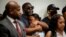 Family members of Rayshard Brooks attend a news conference, June 15, 2020, in Atlanta. The Brooks family and their attorneys spoke days after Brooks was shot and killed by police at a Wendy's restaurant parking lot in Atlanta. 
