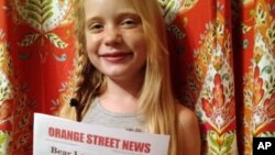 In this September 2015, photo provided by Matthew Lysiak, Hilde Kate Lysiak poses for a photo at her home in Selinsgrove, Pa. Lysiak, a 9-year-old reporter, recently wrote about a suspected murder in her small Pennsylvania town and is defending herself after some locals lashed out about a young girl covering violent crime. (Isabel Rose Lysiak via AP)