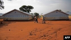 FILE - Refugees walk at the Nyumanzi transit center in Adjumani, Uganda, July 13, 2016. 