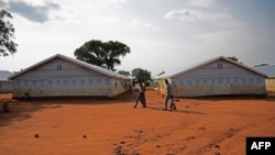 Refugees walk at the Nyumanzi transit center in Adjumani, Uganda, on July 13, 2016. 