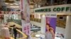 A security officer wearing a face mask stands in a shopping mall with a number of stores that remained closed in Beijing, Feb. 3, 2020. 