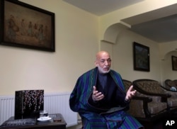 FILE - Former Afghan President Hamid Karzai speaks during an interview with the Associated Press at his house, in Kabul, Afghanistan, June 20, 2021.