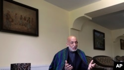 Former Afghan President Hamid Karzai speaks during an interview with the Associated Press at his house, in Kabul, Afghanistan, June 20, 2021. 