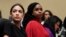 FILE - Rep. Alexandria Ocasio-Cortez, left, and Rep. Ayanna Pressley, D-Mass., center, attend a hearing on Capitol Hill, July 15, 2019.