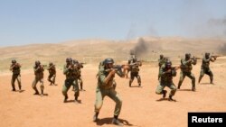 Security forces loyal to Syria's President Bashar al-Assad take part in a field exercise at an undisclosed location. (SANA via Reuters)