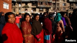 Nepalese people stand in a line outside a polling station to cast their votes during the Constituent Assembly Election in Bhaktapur November 19, 2013. Nepal started voting on Tuesday to elect a special assembly which will draft a constitution aimed at en